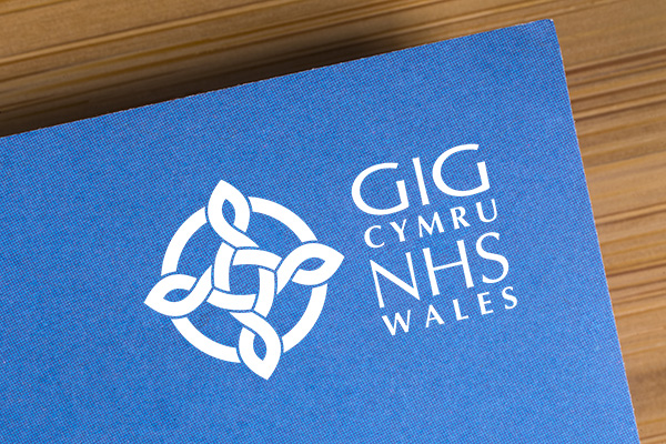 NHS Wales Logo on a book